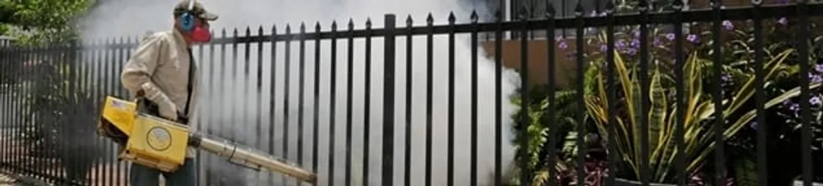 Mosquito control technician fogging a yard perimeter for mosquito reduction in Boulder, CO